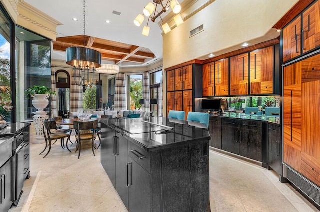 kitchen with coffered ceiling, decorative light fixtures, an inviting chandelier, beamed ceiling, and a center island