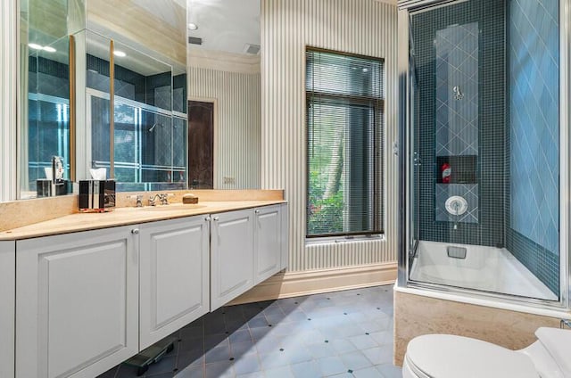 full bathroom featuring vanity, toilet, and enclosed tub / shower combo