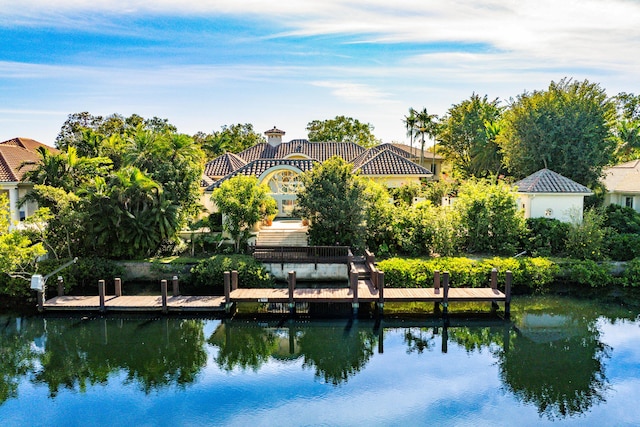 exterior space featuring a boat dock and a water view