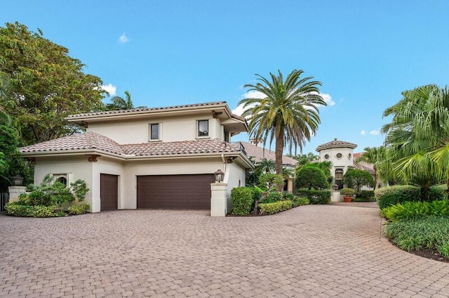 mediterranean / spanish house featuring a garage