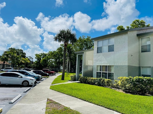 view of property exterior featuring a lawn