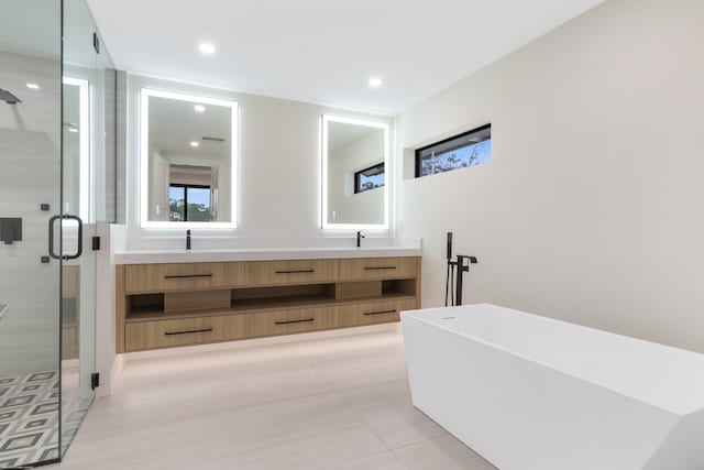 bathroom with vanity, tile patterned floors, and independent shower and bath