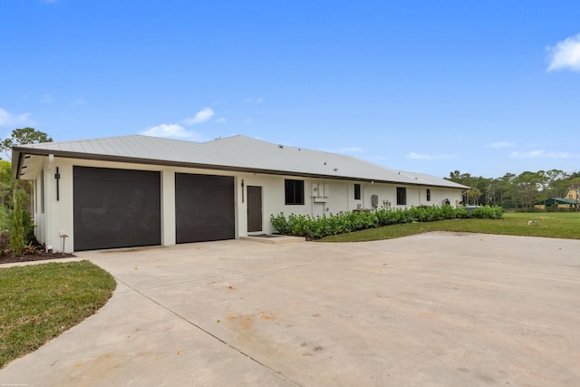 ranch-style home featuring a garage and a front yard