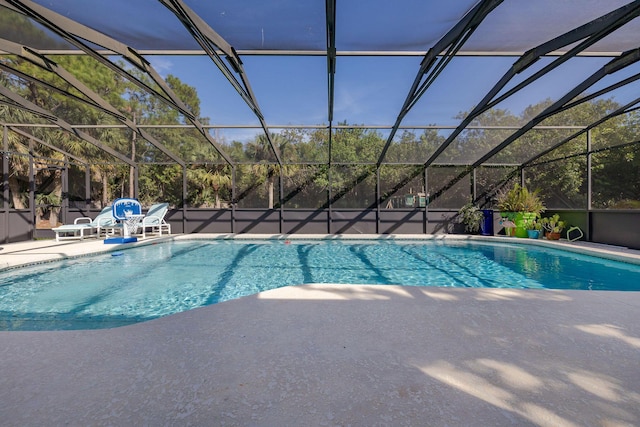 view of pool with a patio area and a lanai