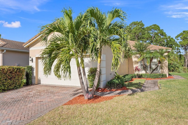 view of front facade with a front yard and a garage