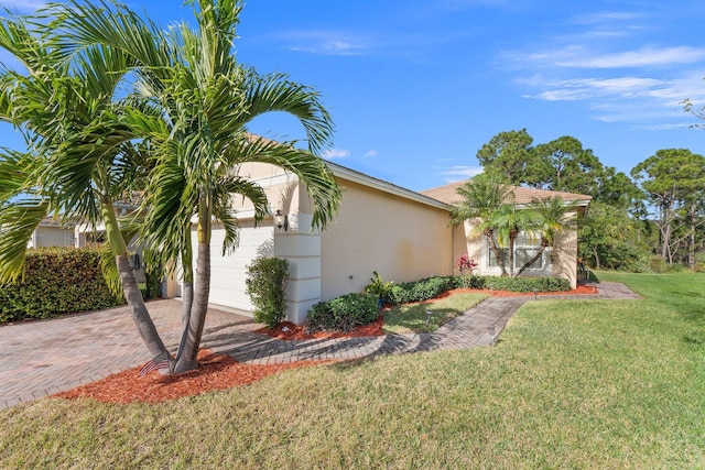 view of side of property with a yard and a garage