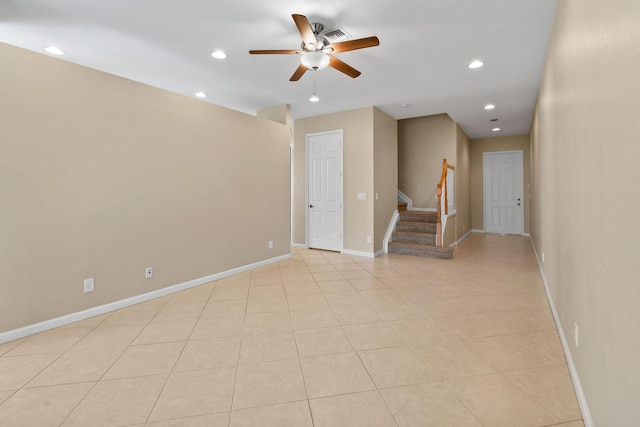 tiled spare room featuring ceiling fan