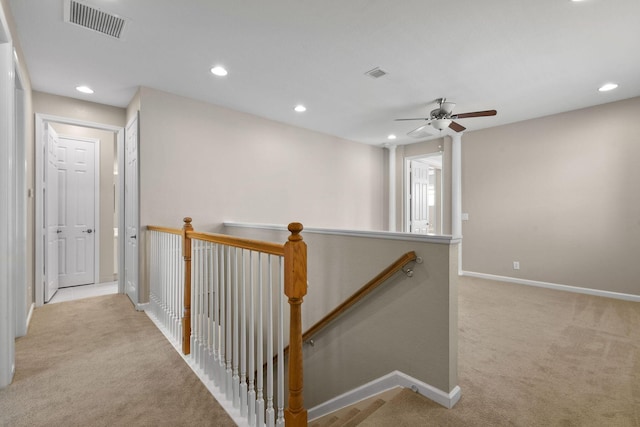 hallway with light colored carpet