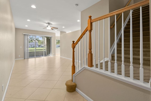 stairs with tile patterned flooring and ceiling fan