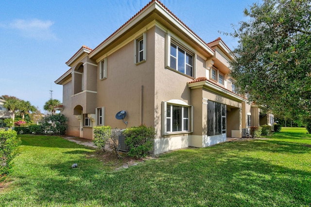 view of side of property with a lawn