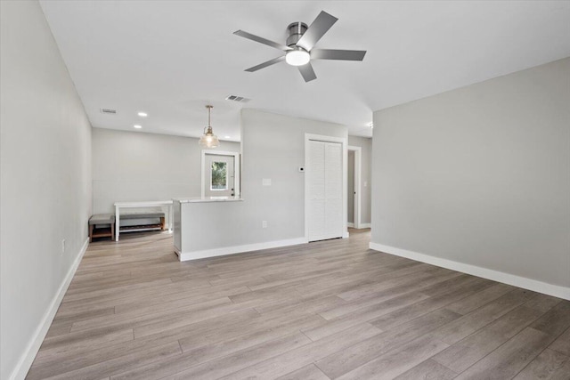 spare room with light wood-type flooring and ceiling fan