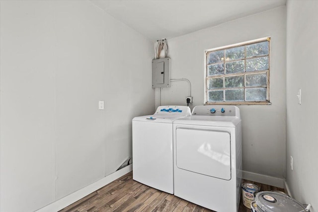 clothes washing area featuring electric panel, separate washer and dryer, and dark hardwood / wood-style floors