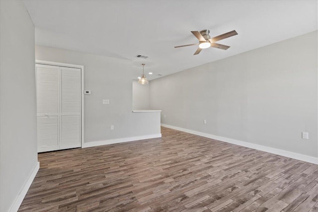 empty room featuring hardwood / wood-style floors and ceiling fan