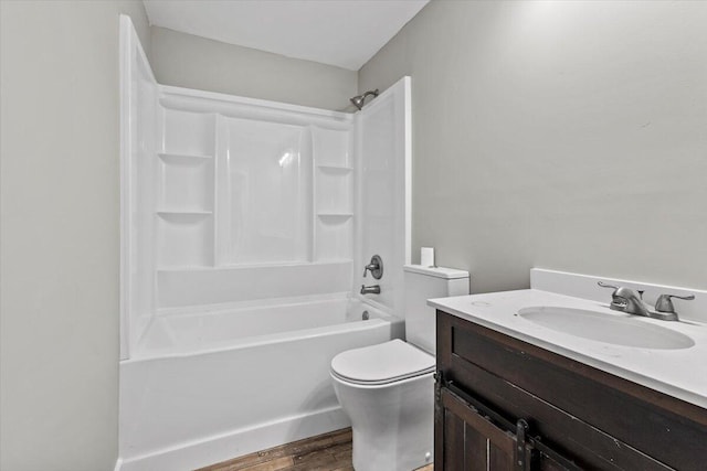 full bathroom featuring toilet, hardwood / wood-style floors, vanity, and bathing tub / shower combination