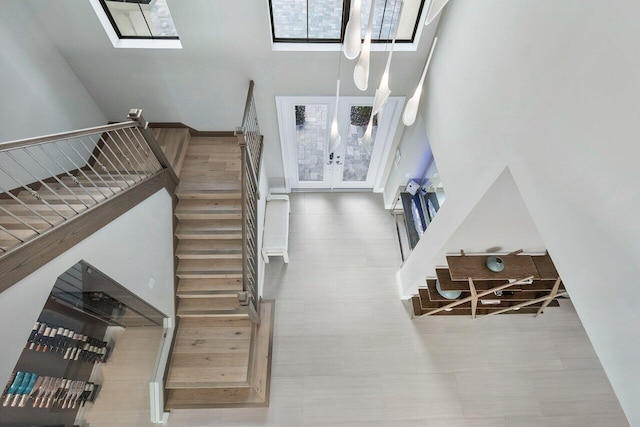 entrance foyer with a towering ceiling and french doors