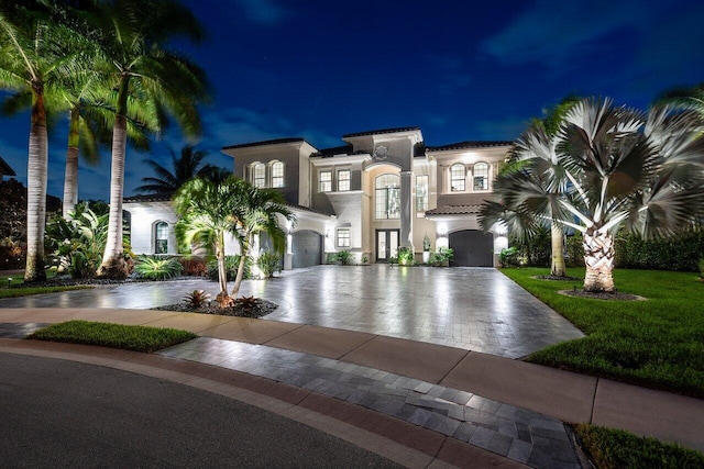 mediterranean / spanish-style home with french doors and a garage