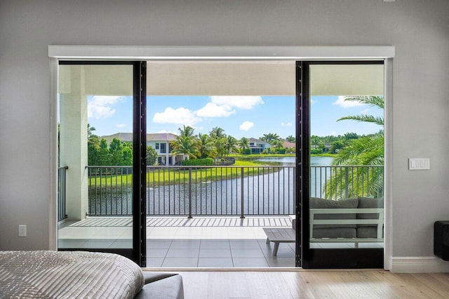 entryway featuring hardwood / wood-style floors and a water view