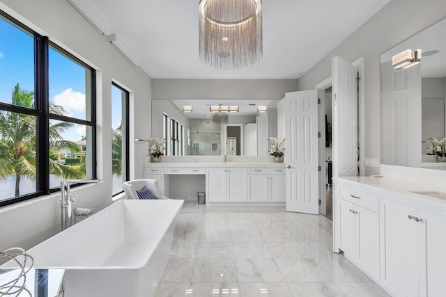 bathroom with vanity, separate shower and tub, and a wealth of natural light