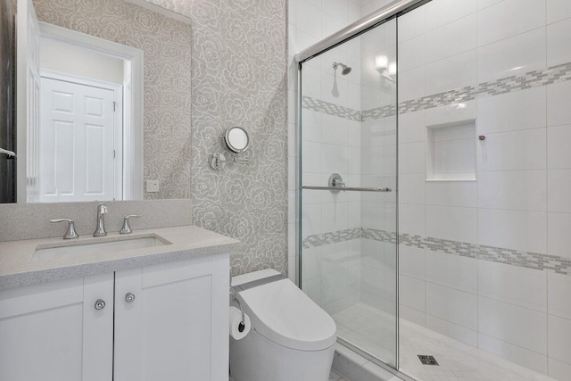 bathroom featuring vanity, toilet, and walk in shower