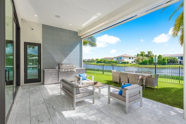 view of patio / terrace with an outdoor living space, a water view, and area for grilling