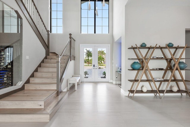 foyer entrance featuring french doors and a high ceiling