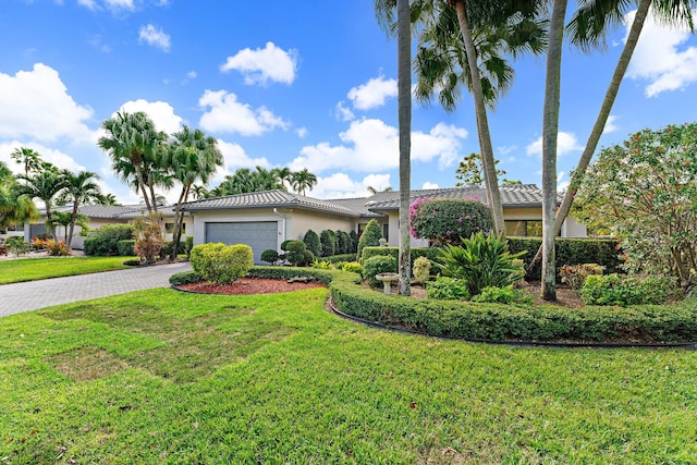 view of front of property featuring a front yard and a garage