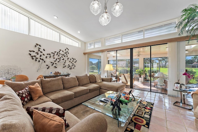 living room featuring ceiling fan, a towering ceiling, and light tile patterned floors