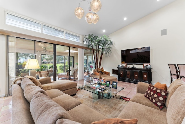 tiled living room featuring ceiling fan with notable chandelier and high vaulted ceiling