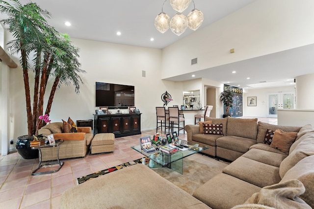 living room with french doors and a chandelier