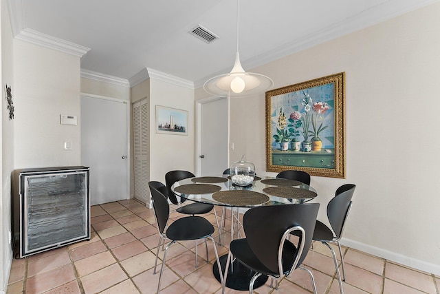 dining area featuring wine cooler, crown molding, and light tile patterned floors