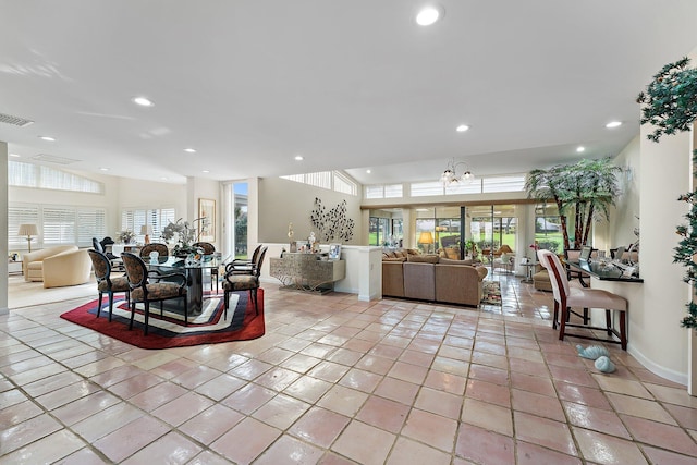 tiled dining space with plenty of natural light and an inviting chandelier