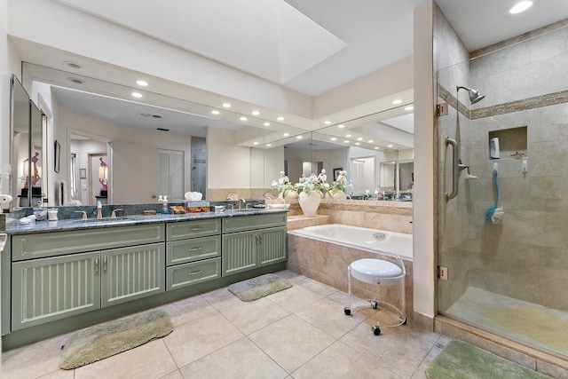 bathroom with tile patterned flooring, vanity, and shower with separate bathtub