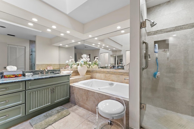 bathroom with tile patterned floors, vanity, and shower with separate bathtub