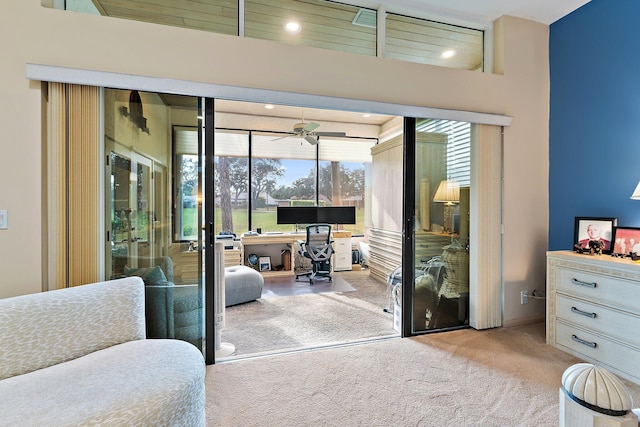 doorway with light colored carpet and ceiling fan