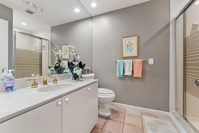 bathroom featuring tile patterned flooring, vanity, toilet, and a shower with door