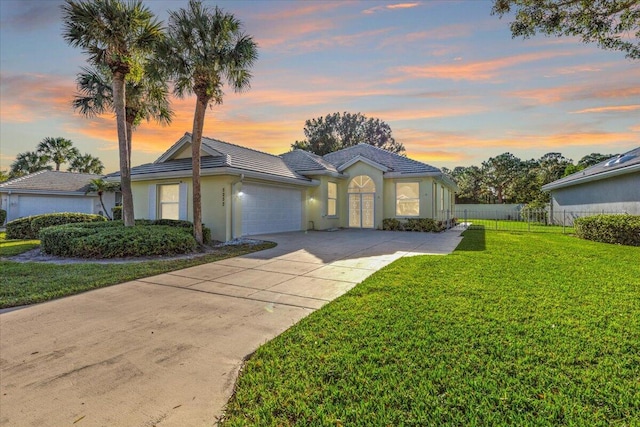 view of front of home with a lawn and a garage