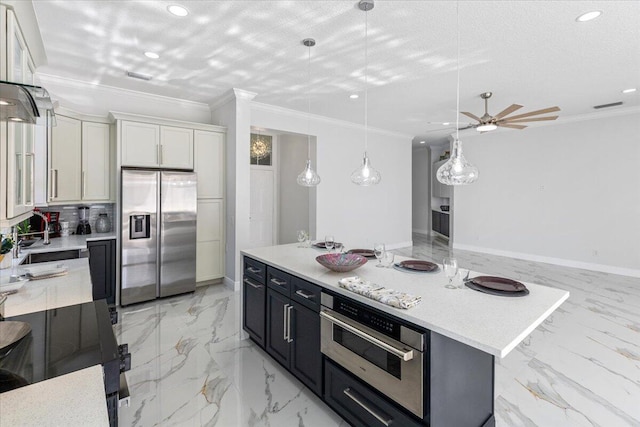 kitchen featuring sink, white cabinets, stainless steel appliances, and a kitchen island