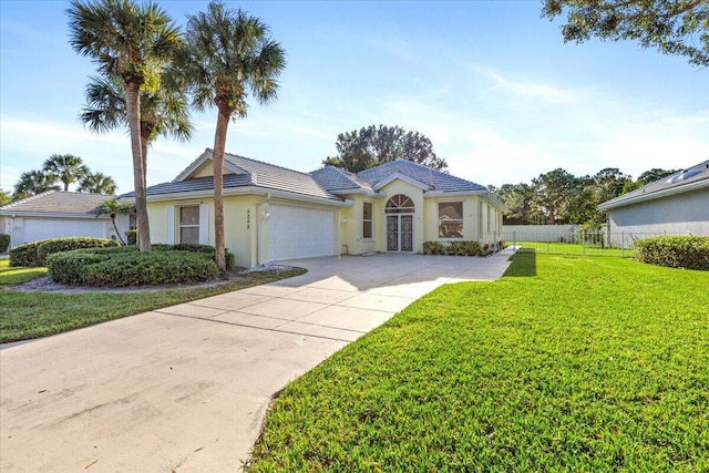 view of front of property with a front yard and a garage