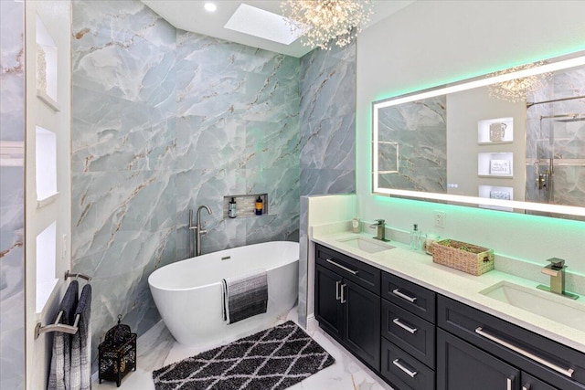 bathroom with a tub to relax in, a skylight, vanity, and tile walls