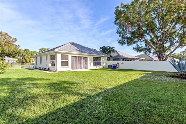 rear view of house with a lawn