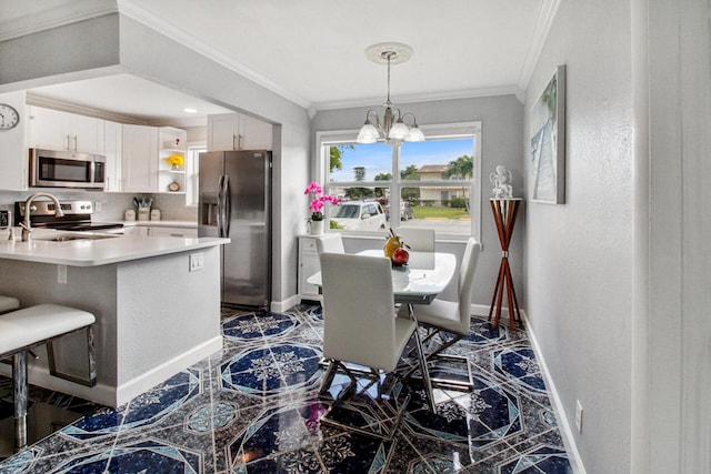 kitchen with stainless steel appliances, kitchen peninsula, crown molding, a chandelier, and white cabinets