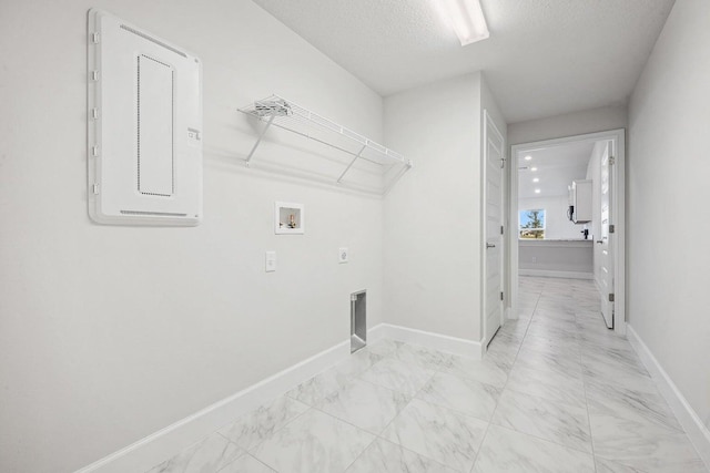 clothes washing area featuring washer hookup, electric dryer hookup, and a textured ceiling