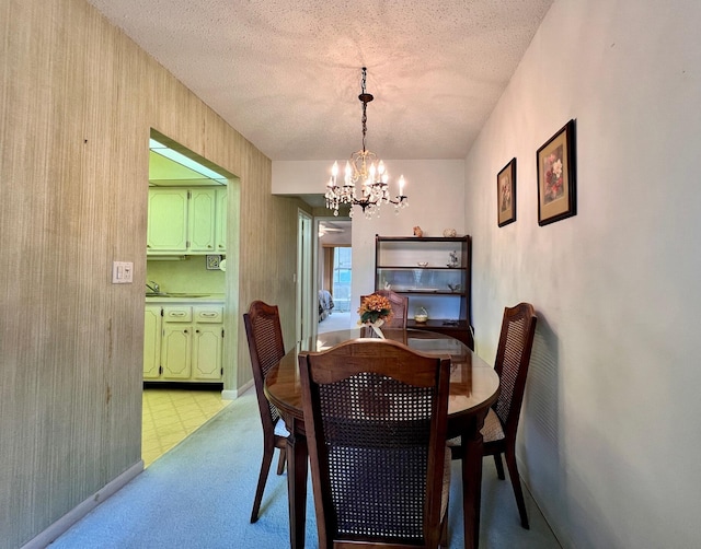 dining room with a textured ceiling and a notable chandelier