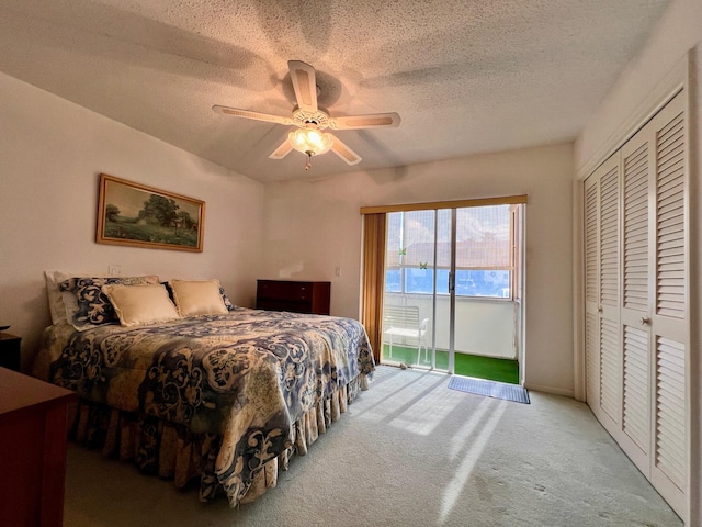 bedroom with carpet, ceiling fan, access to exterior, a textured ceiling, and a closet