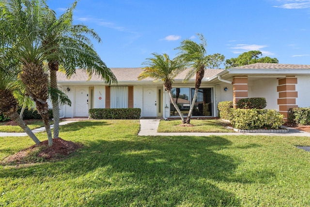 ranch-style home with a front yard