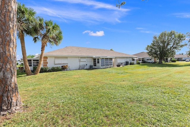 back of property featuring a yard