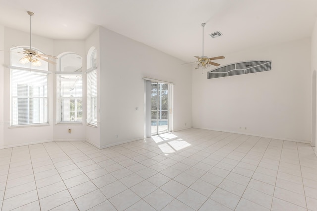 tiled spare room featuring plenty of natural light and ceiling fan