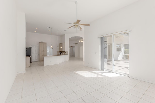 unfurnished living room with ceiling fan and light tile patterned flooring