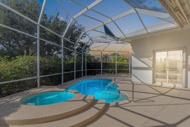 view of pool featuring glass enclosure and a patio area