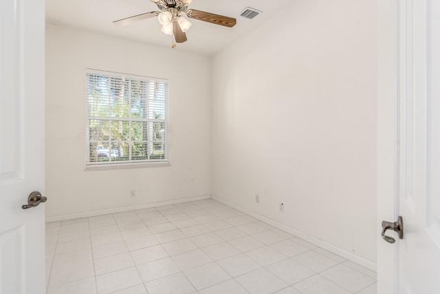 tiled empty room featuring ceiling fan